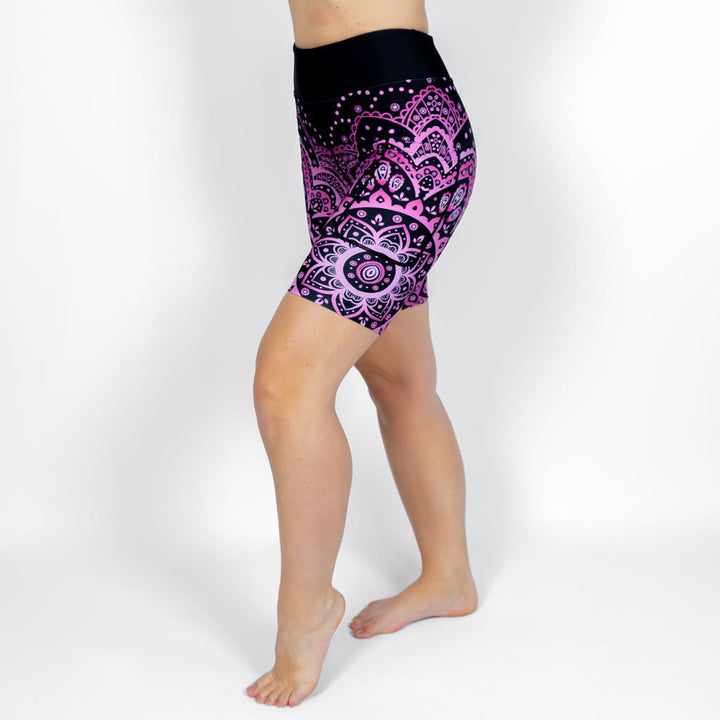 Kvinde i højtaljede mønstrede shorts. Shorts har lommer på begge sider. Meget elastiske og squat proof.
